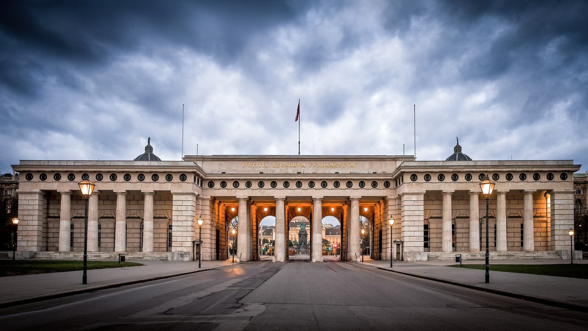 Grand ceremonial gate entrance under dramatic sky, Vienna tour