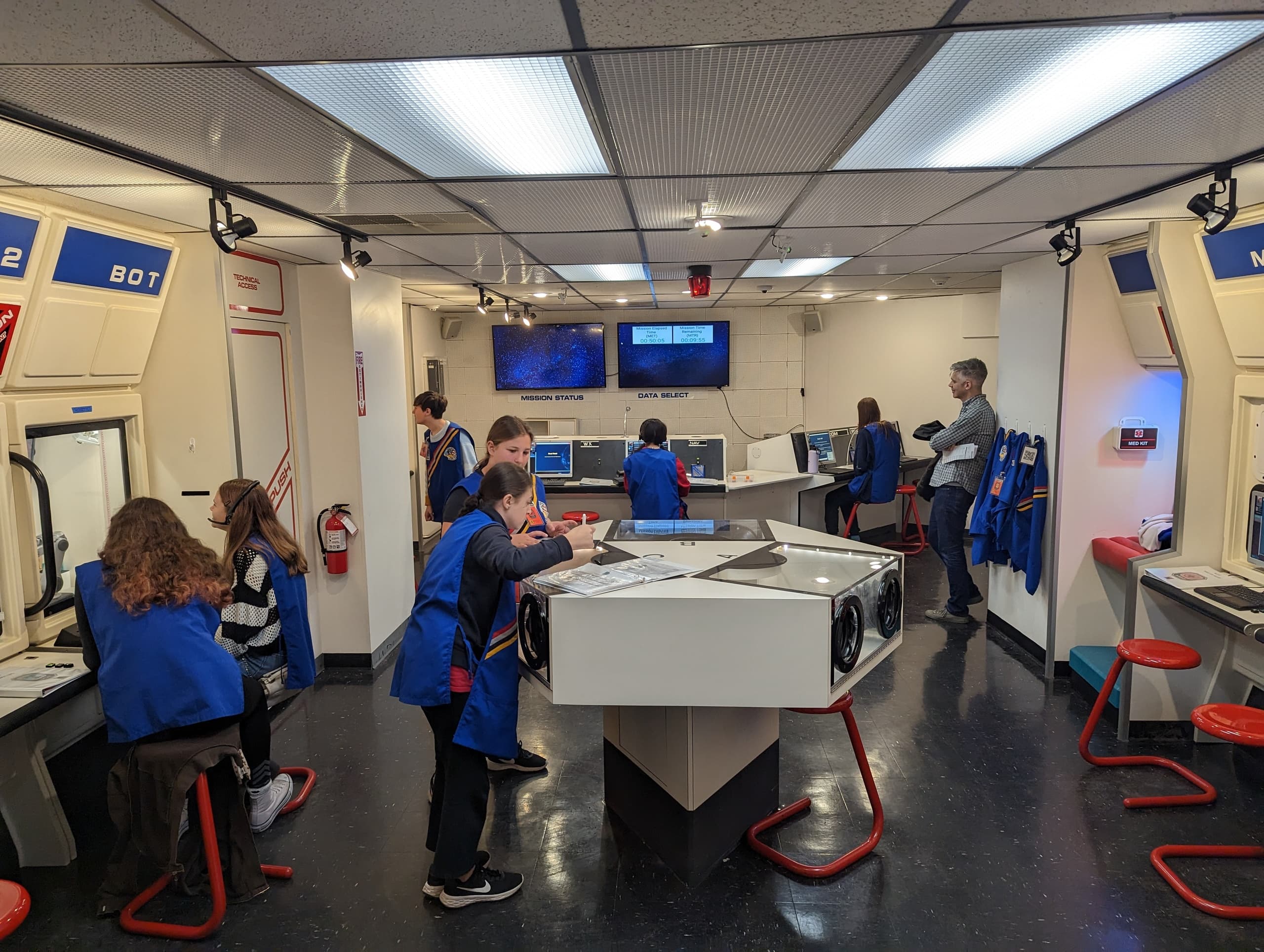 Students exploring interactive space lab exhibits in classroom