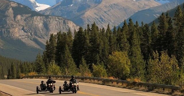 Group motorcycle touring on scenic mountain highway