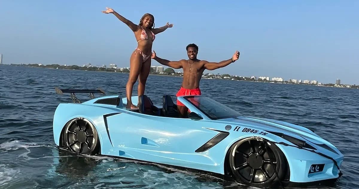 Couple standing on car-shaped boat in Miami waters, posing