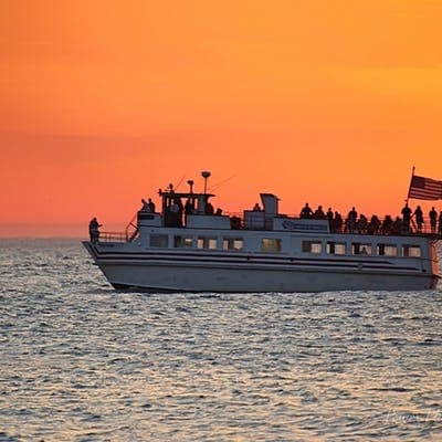 Sunset sightseeing cruise silhouette on Lake Michigan waters