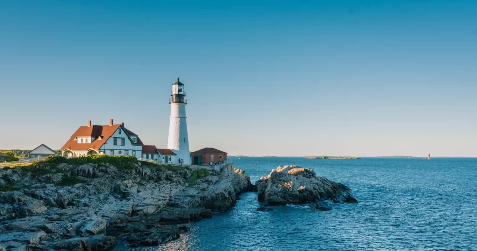 Panoramic rocky coastline with lighthouse, ocean sightseeing view
