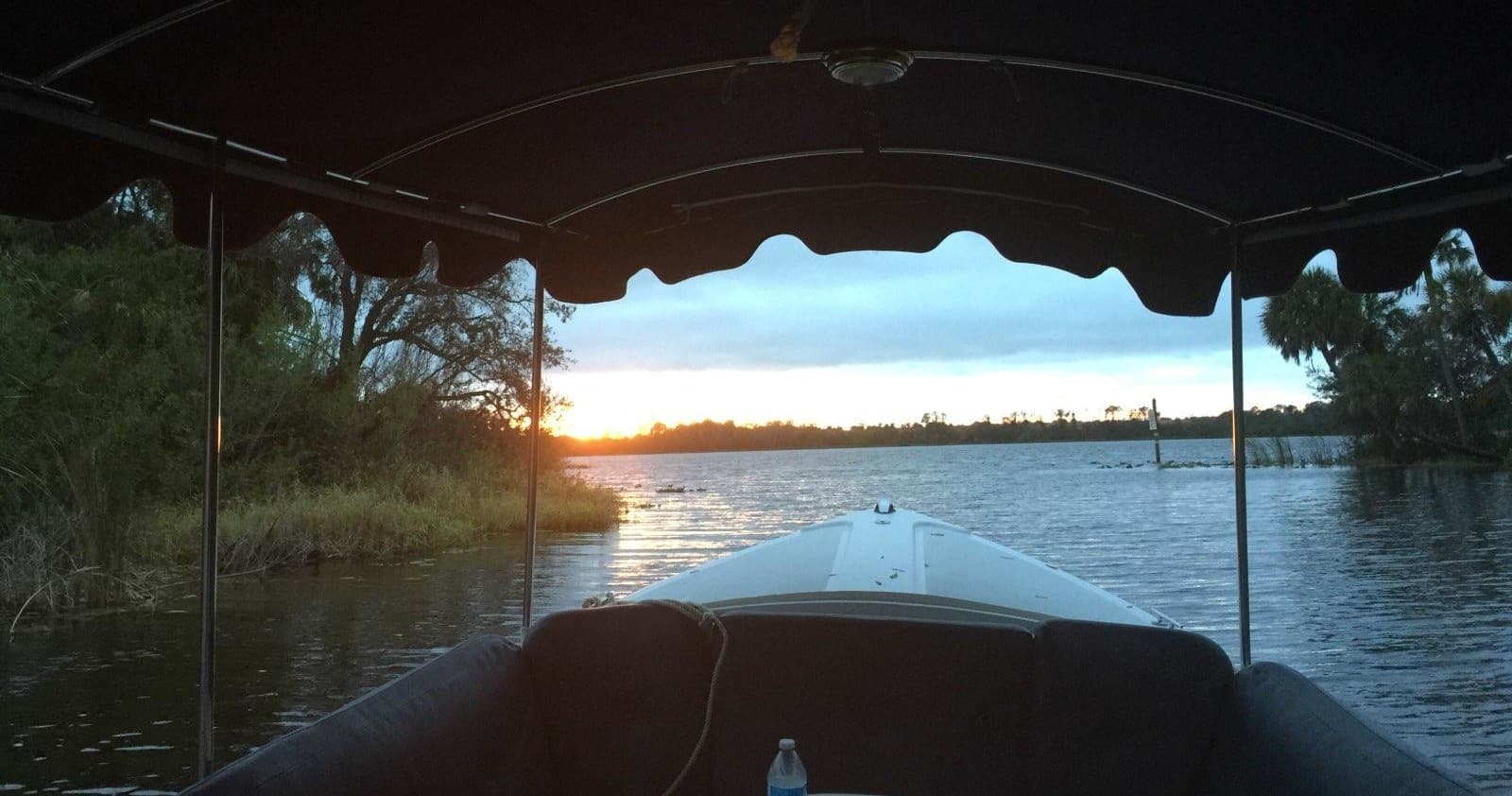 Front view from covered boat entering Florida mangroves at dawn
