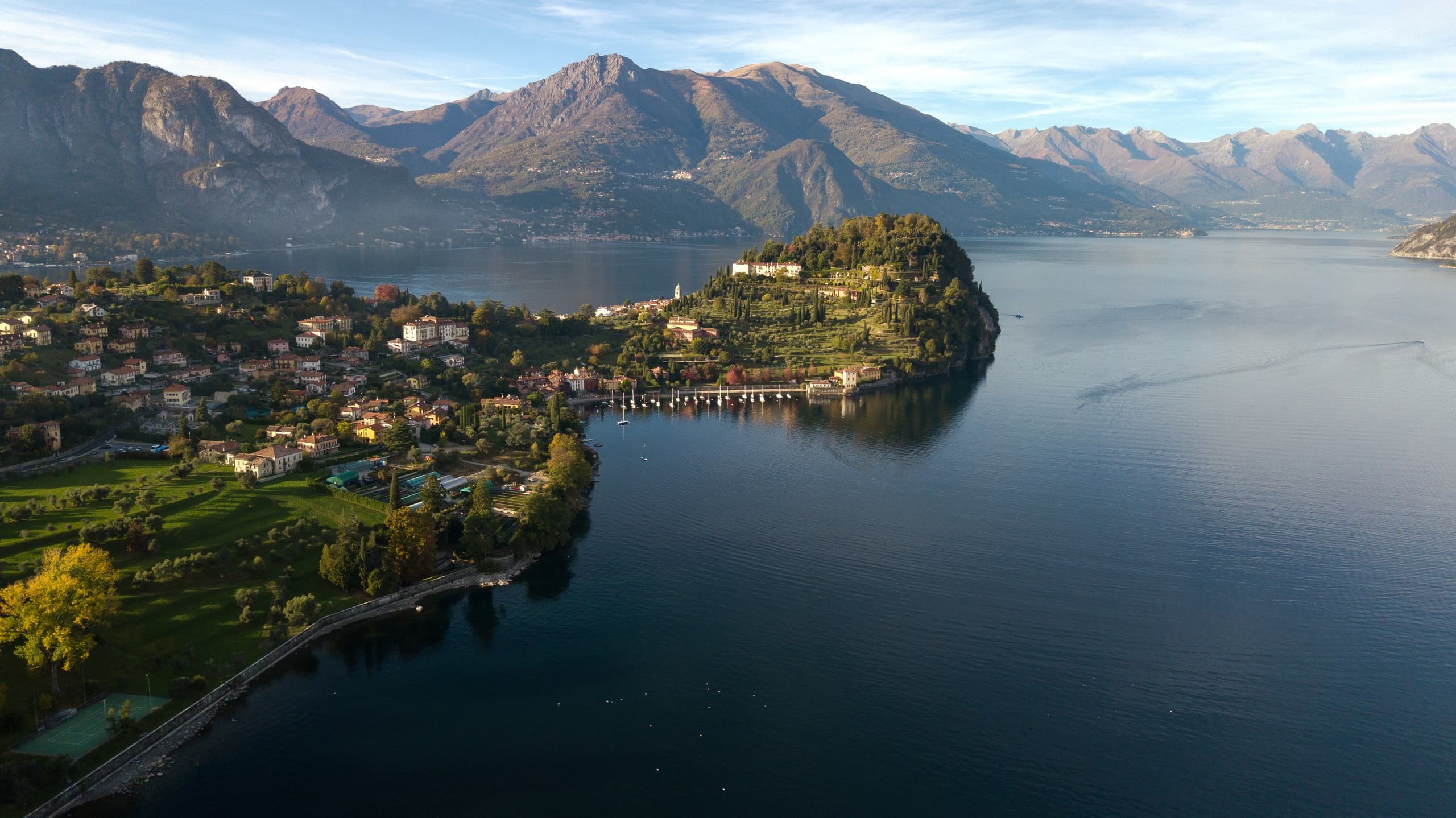 Aerial peninsula over alpine lake with coastal hiking views