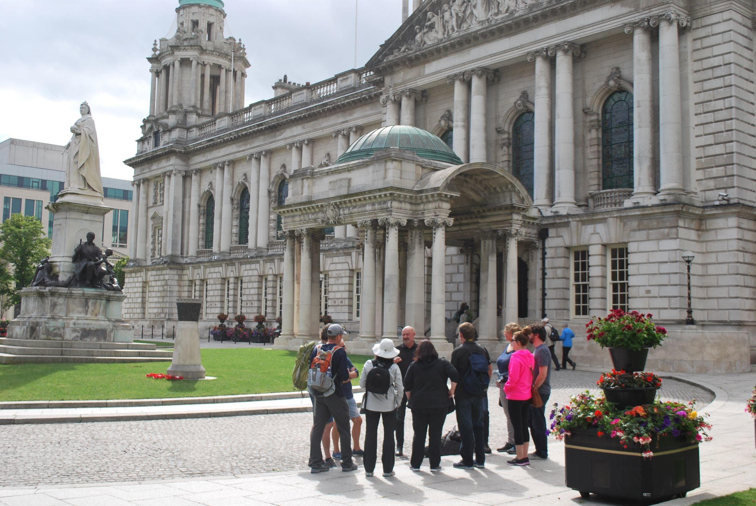 Guided walking tour group in front of historic civic building