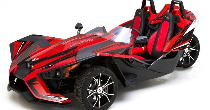 Red Polaris Slingshot three-wheeler on white studio background