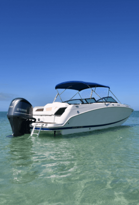 Center-console boat moored in crystal clear turquoise water