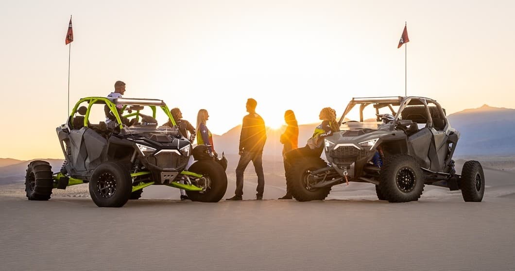 UTV group parked on desert ridge at golden sunset vista