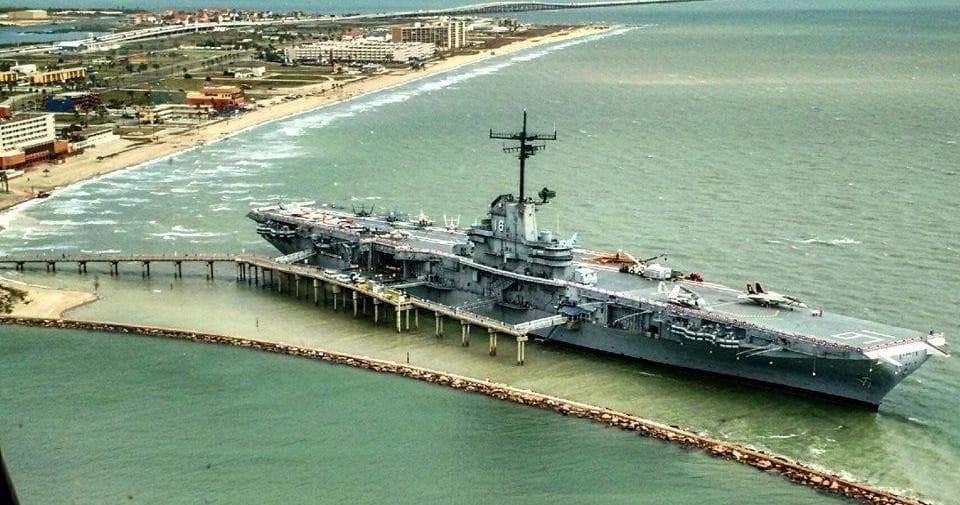 Historic aircraft carrier museum docked along coastal pier