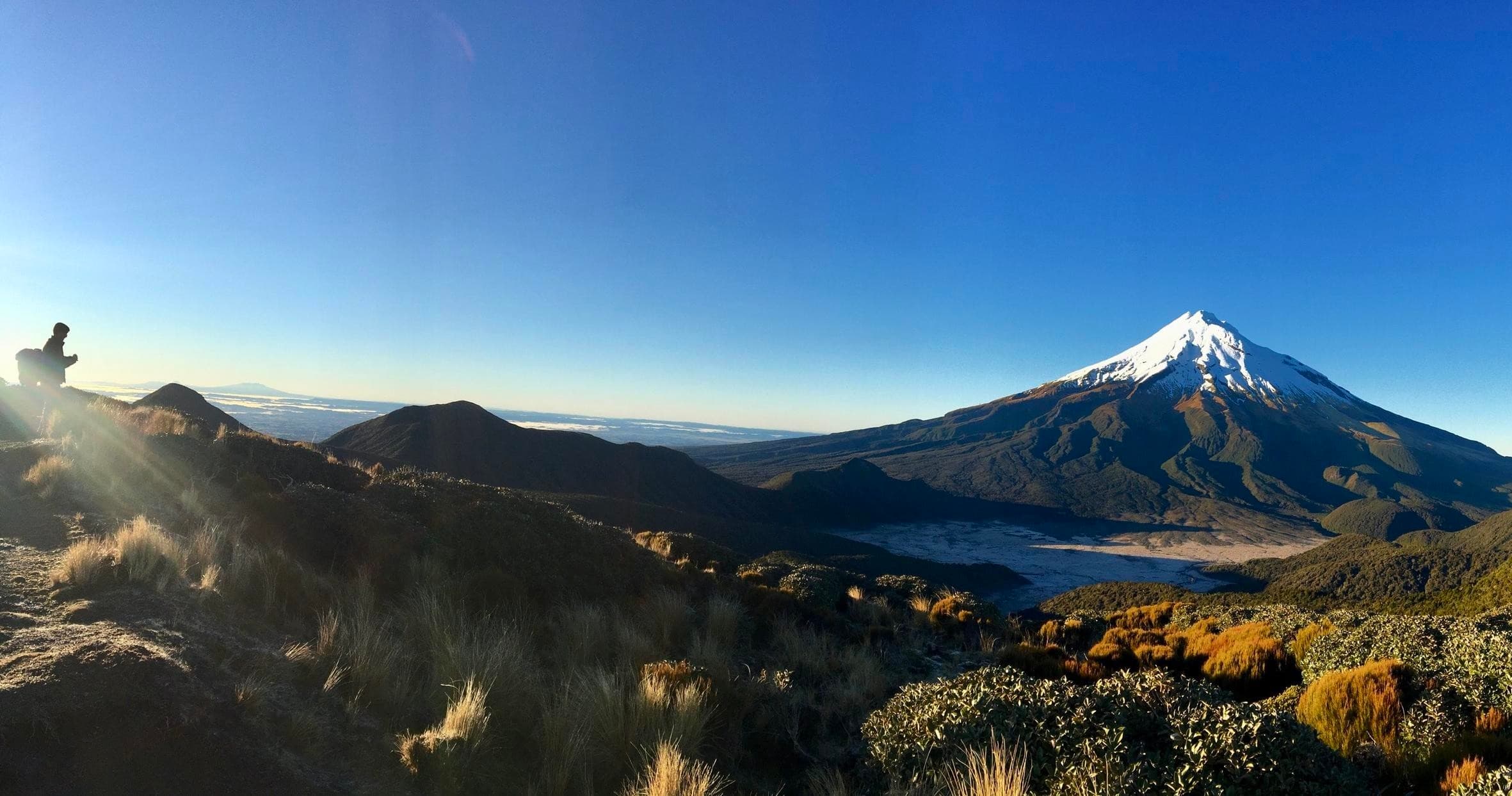 Panoramic Mount Taranaki vista with alpine hiking ridgeline