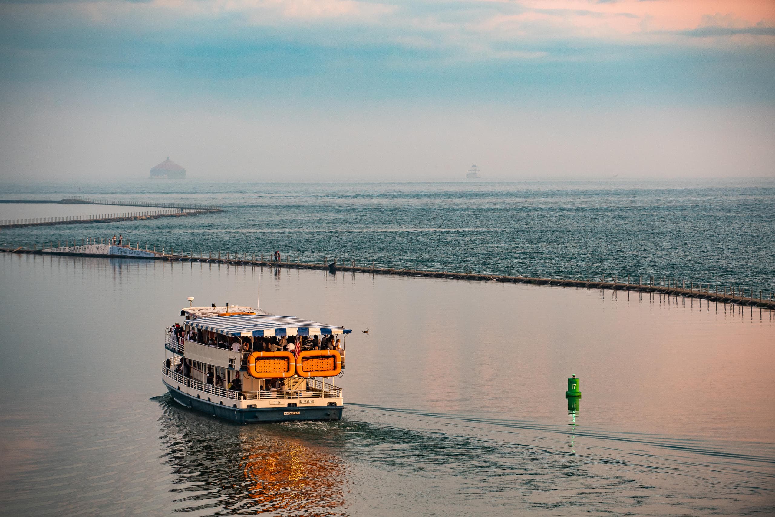 Sightseeing ferry cruising through calm coastal harbor waters