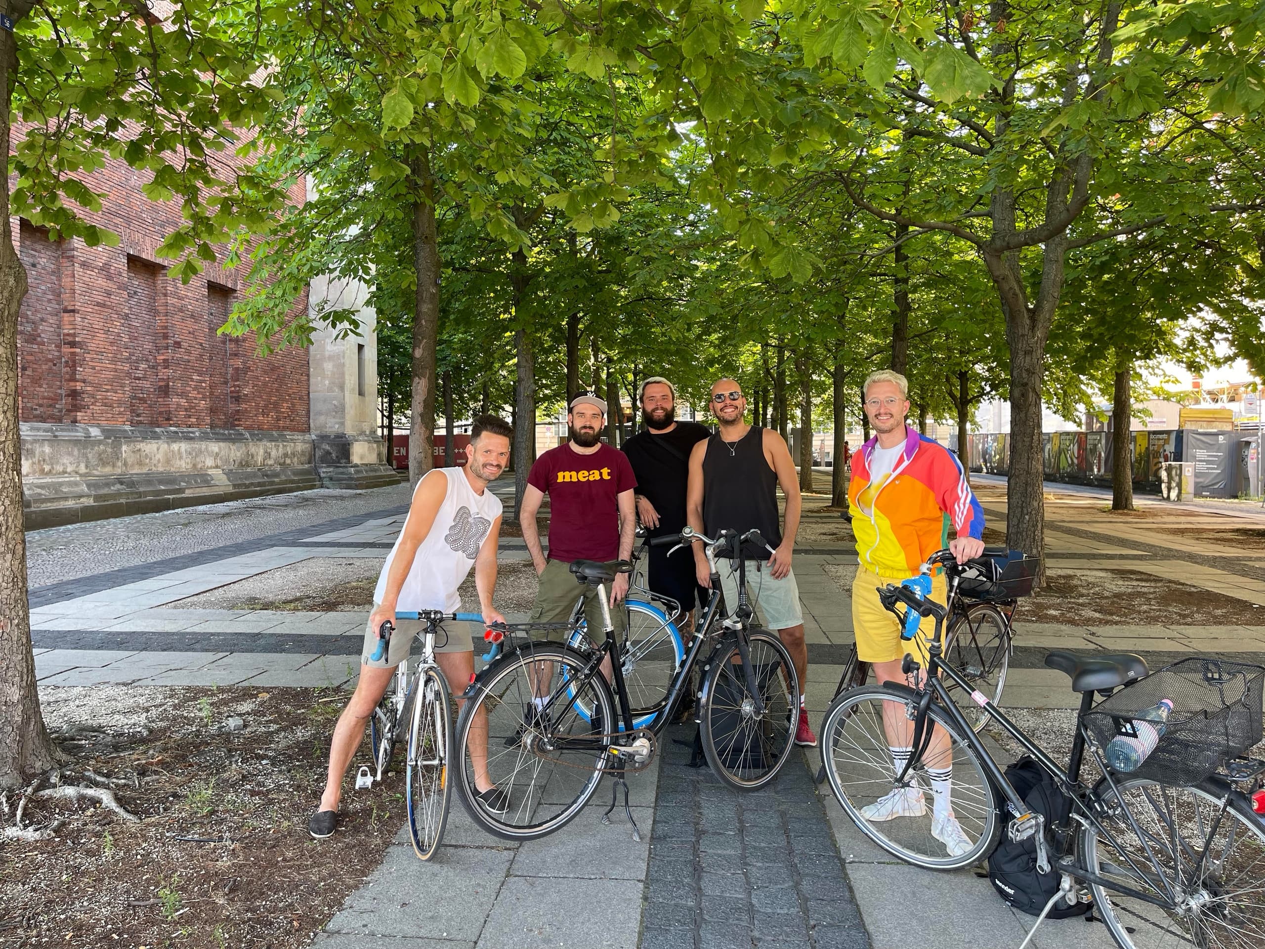 Cyclists on a guided bike tour under leafy trees in Leipzig