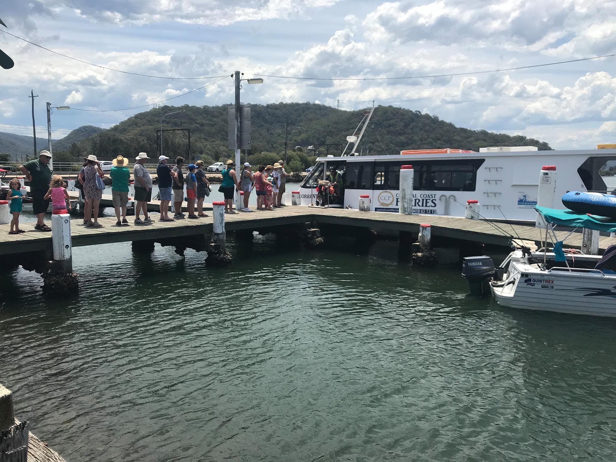 Passengers boarding ferry at coastal pier for island cruises
