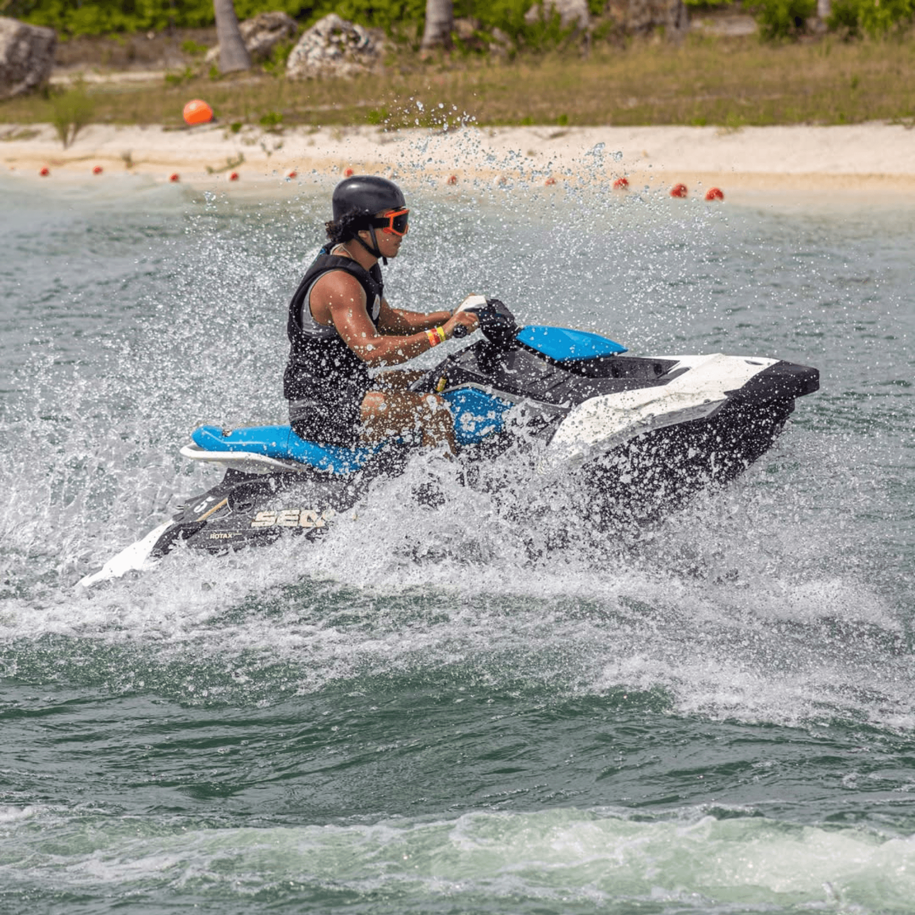 Jet ski rider carving through choppy turquoise water at lagoon