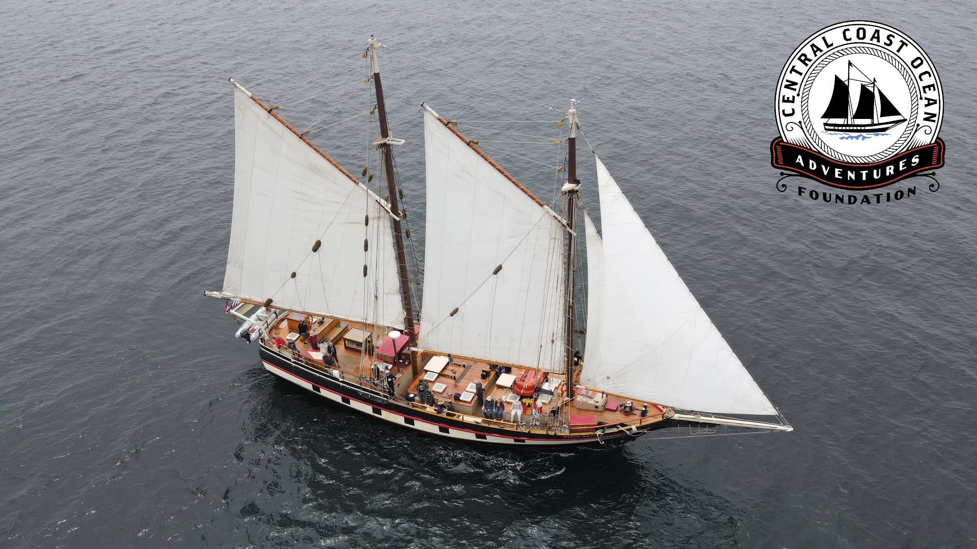 Aerial shot of traditional schooner on open ocean, calm seas