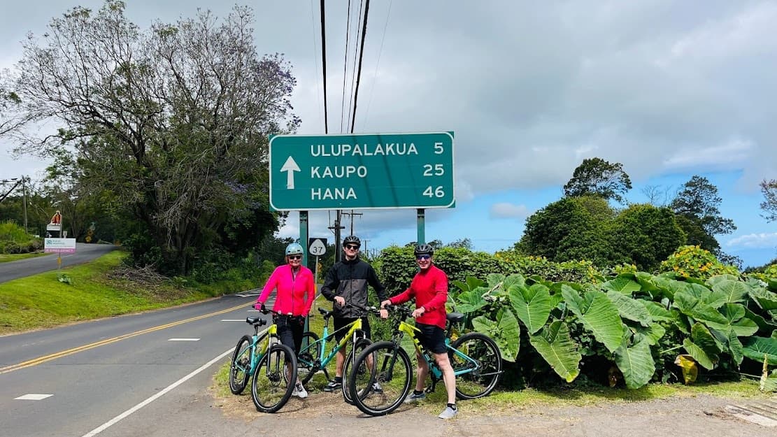 Bicyclists by Ulupalakua road sign on Maui coastal route