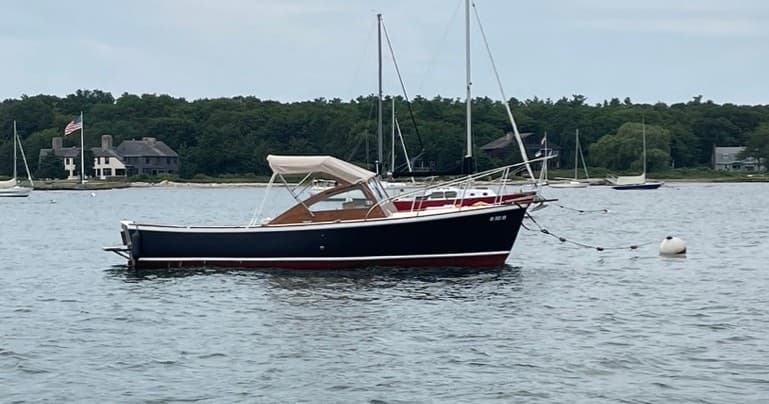 Small motor-sailor anchored in Buzzards Bay waters, scenic harbor