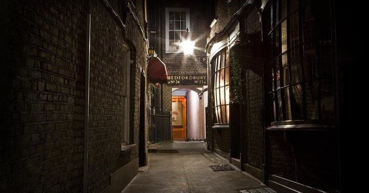 Nighttime Victorian alleyway in London for guided Ripper tour