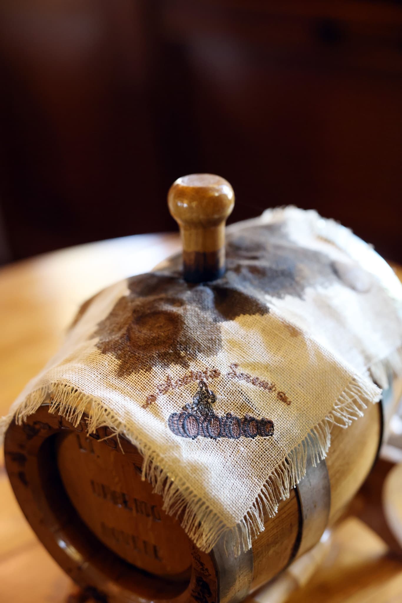 Aged oak barrel with cloth cover inside traditional acetaia