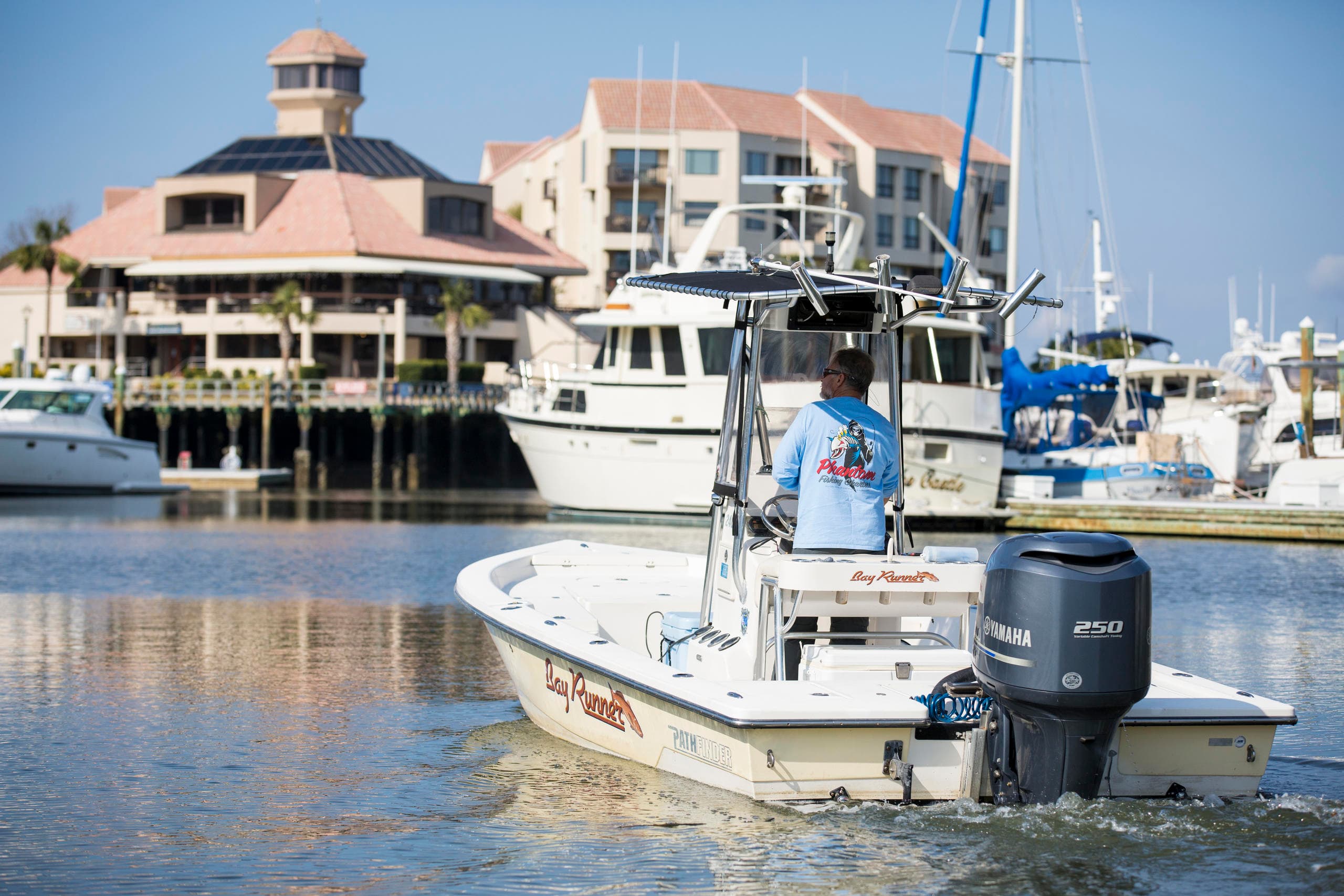 Fishing charter boat at marina, coastal harbor departure