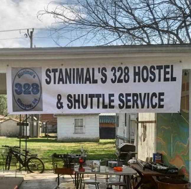 Outdoor hostel sign for Stanimal's 328 hostel and shuttle