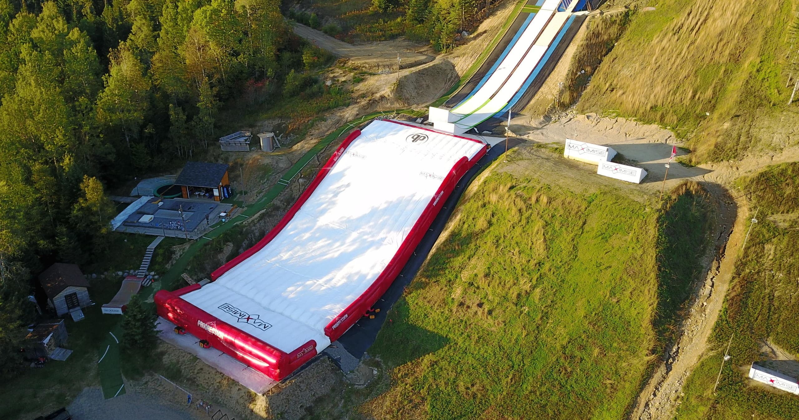 Aerial view of big airbag landing and ski jump hillside venue