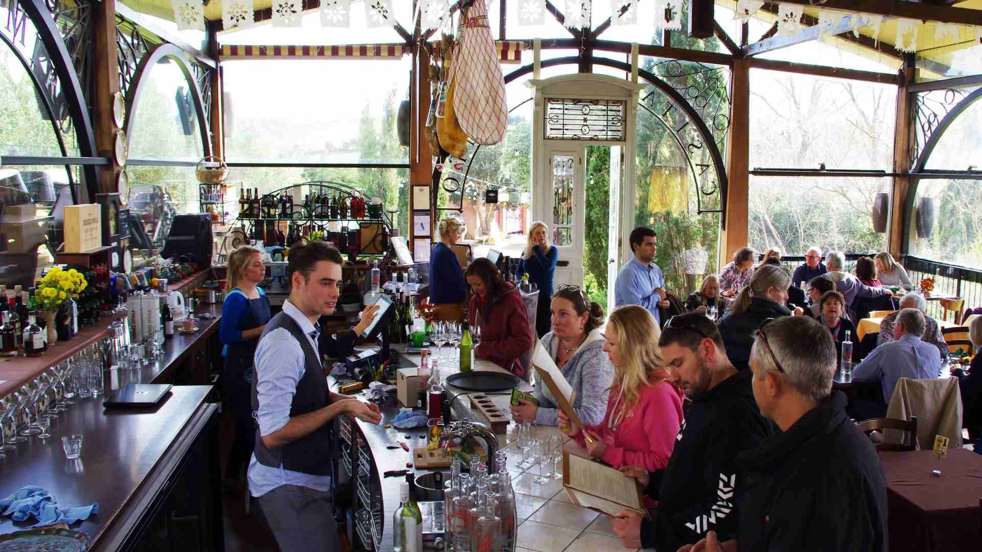 Guests sampling wine inside busy Waiheke Island tasting room