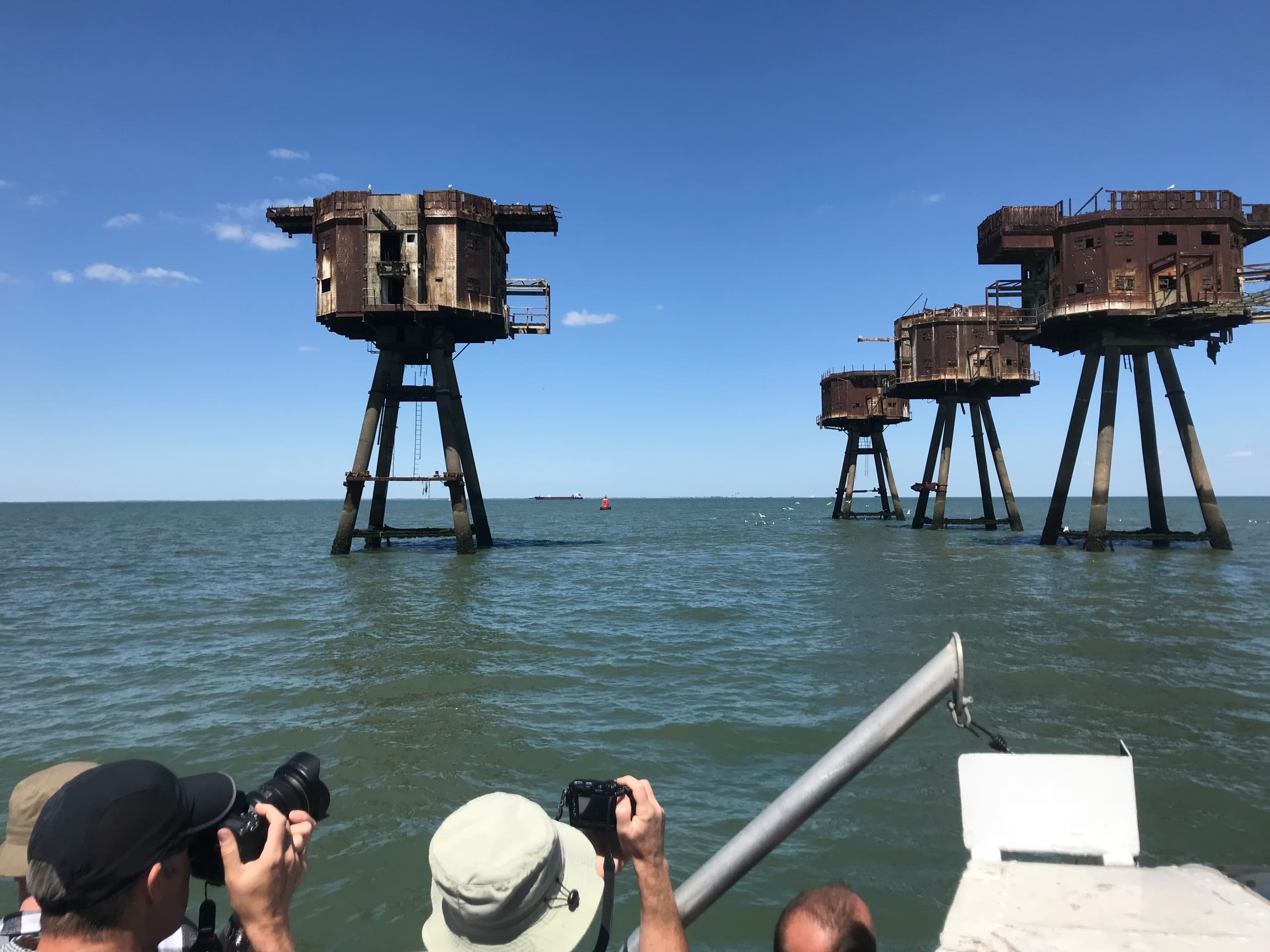 Photographers capturing Maunsell Sea Forts from tour boat