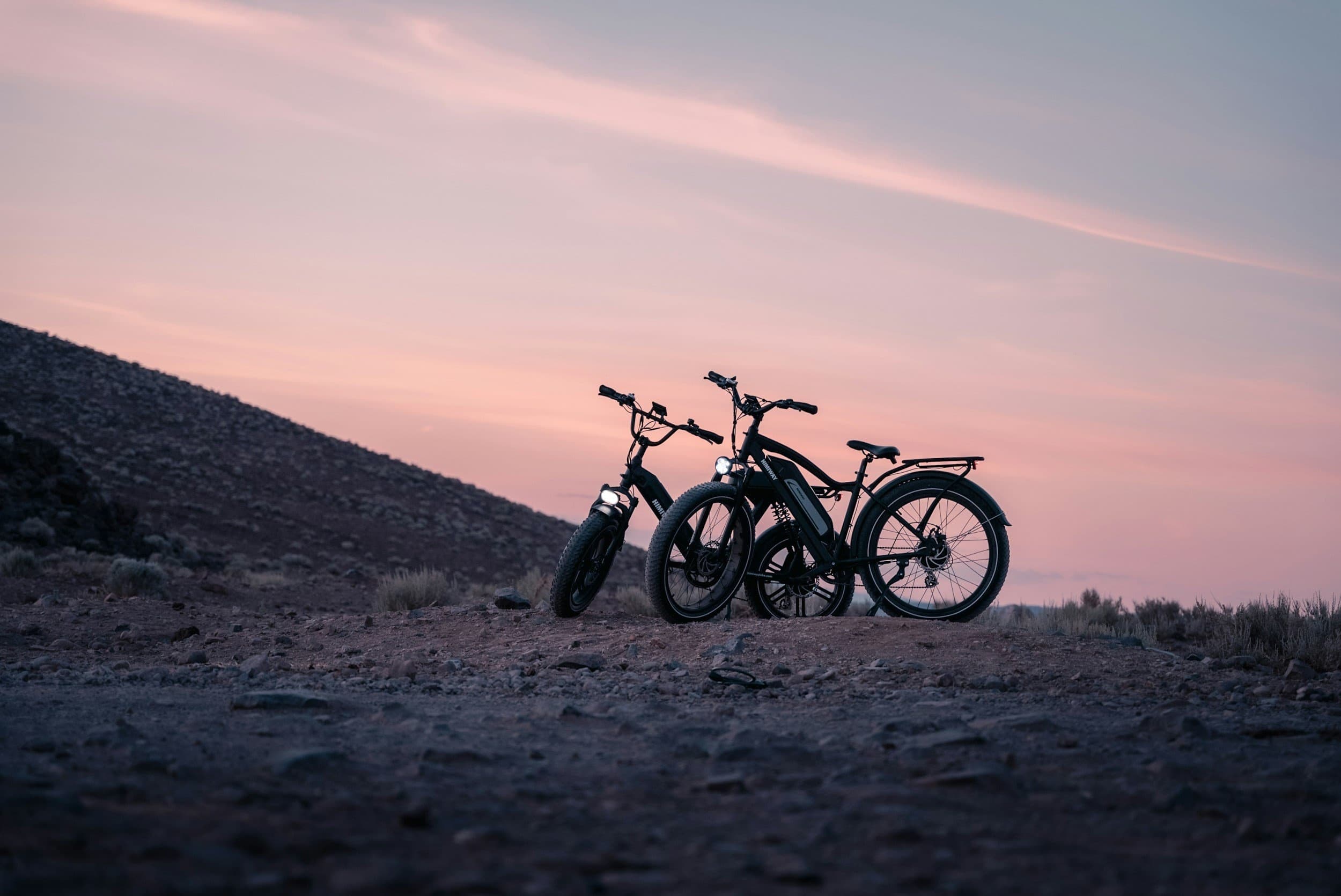 E-bikes parked on desert shoreline at Lake Powell at sunset