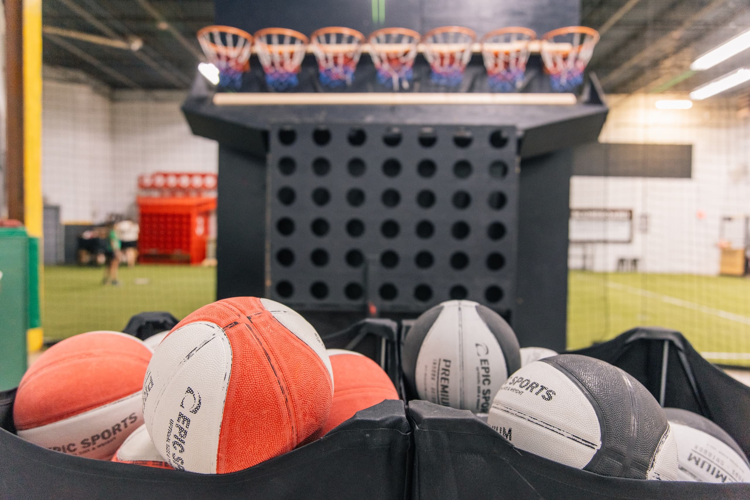 Close-up basketballs in indoor training facility foreground
