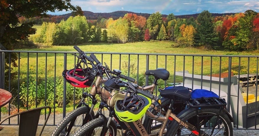 E-bikes lined on deck overlooking Vermont fall foliage