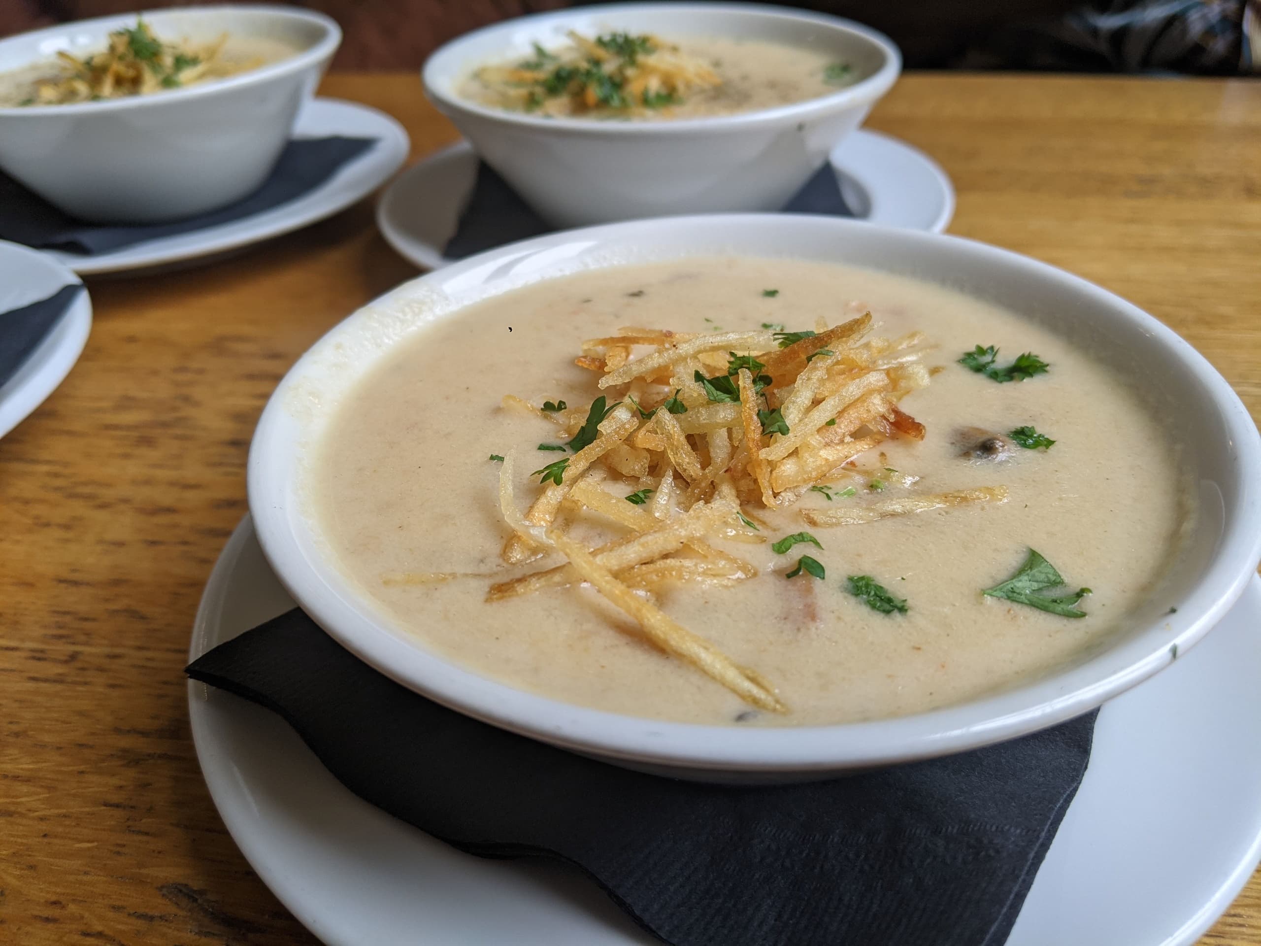 Creamy soup bowls served at a cozy cafe, comfort food tasting