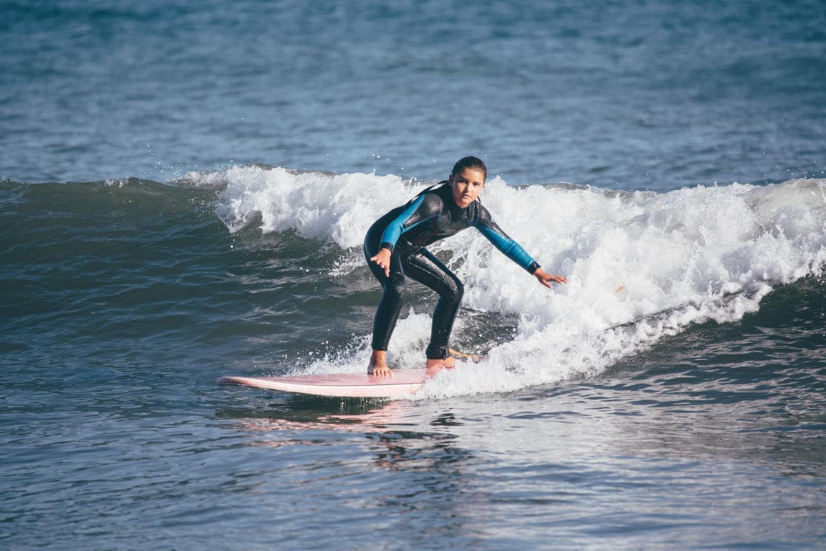 Experienced surfer carving a wave close to the shoreline