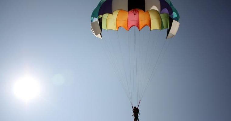 Solo parasailer silhouette over open sky above Chesapeake Bay