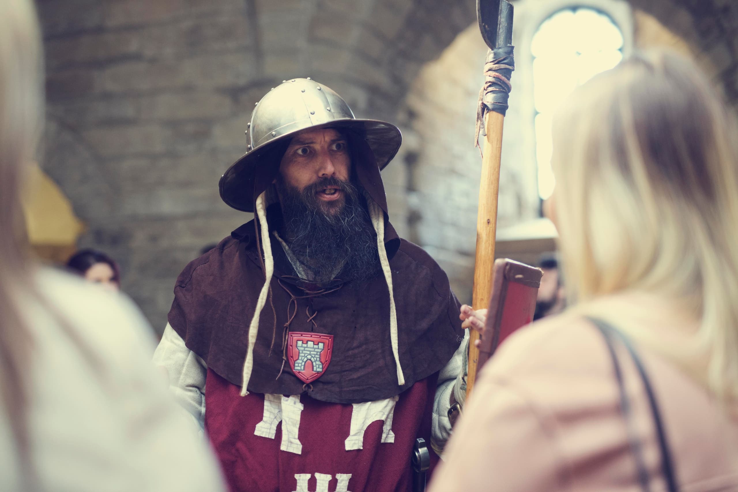 Costumed guide leading castle tour inside historic Newcastle keep