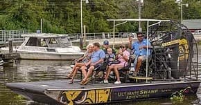 Airboat tour with passengers in Louisiana swamp, wildlife ride