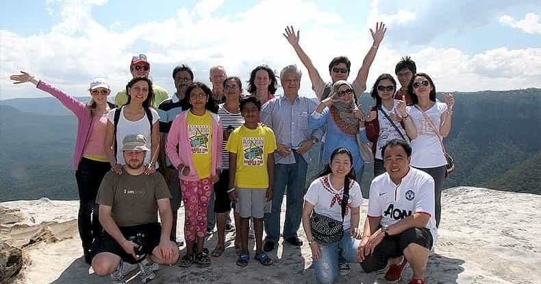 Tour group enjoying scenic cliff-top hike and lookout in Blue Mountains