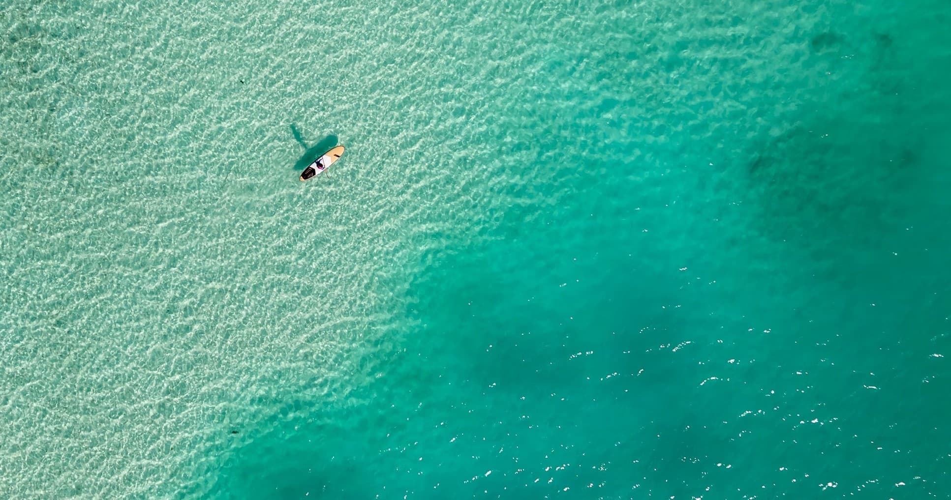 Stand Above the Reef: Crystal Clear Paddle Boarding at Questelles Beach