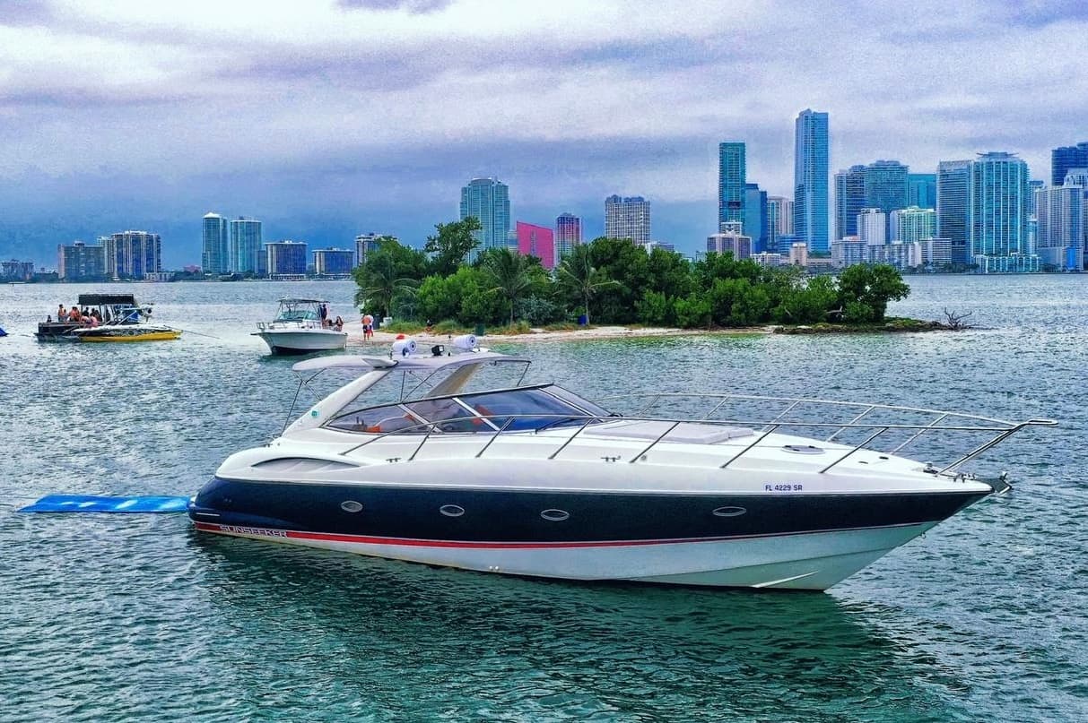 Powerboat cruising near city skyline and island park waterfront