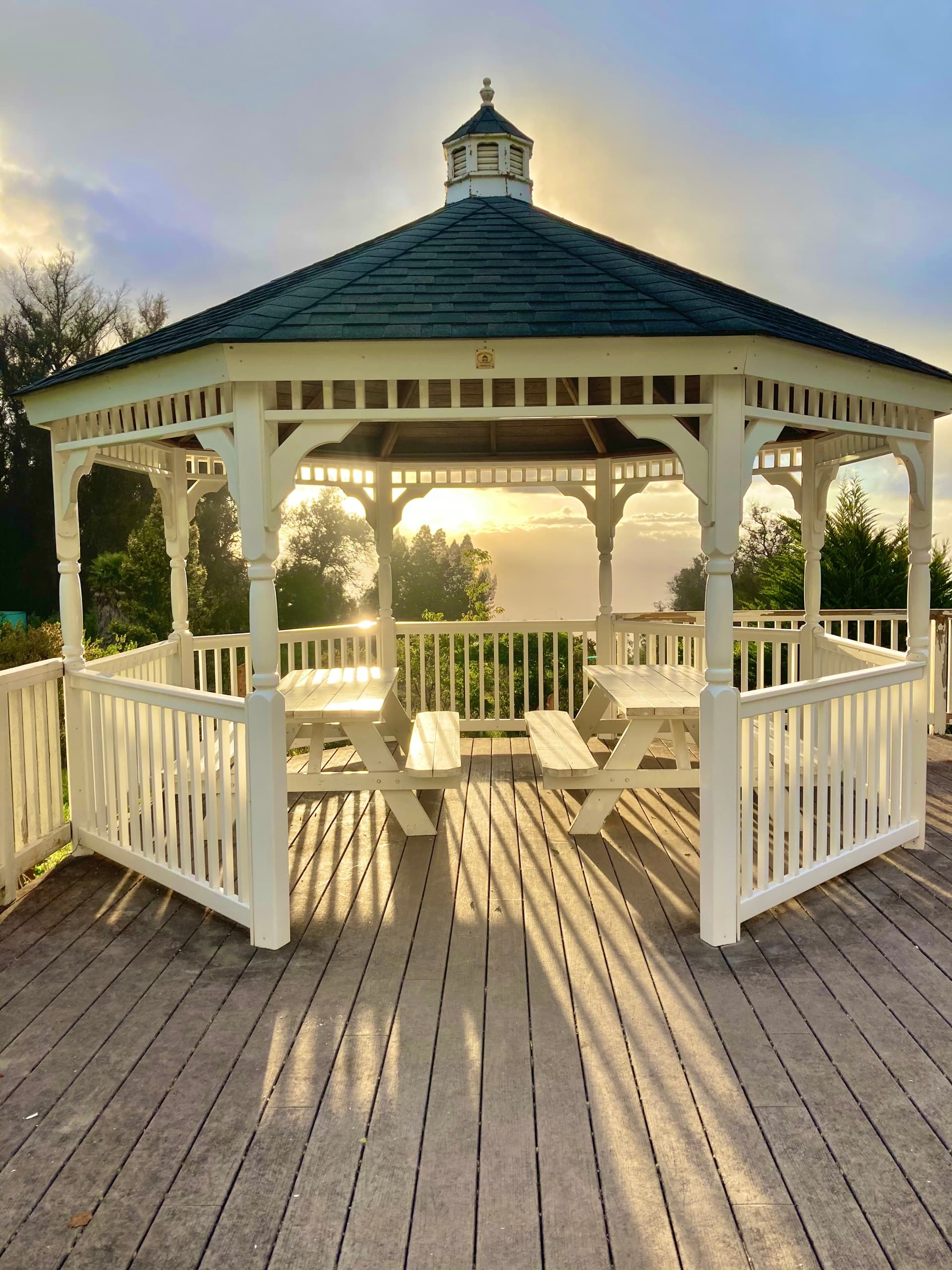 White gazebo overlooking sunset deck at Maui tea farm viewpoint