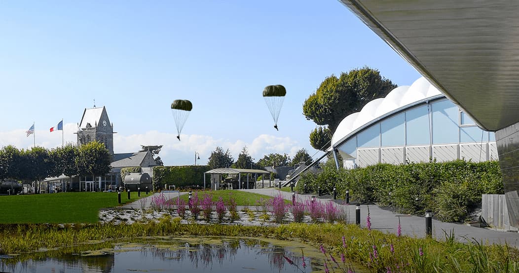 Parachutists landing near airborne museum park in Normandy