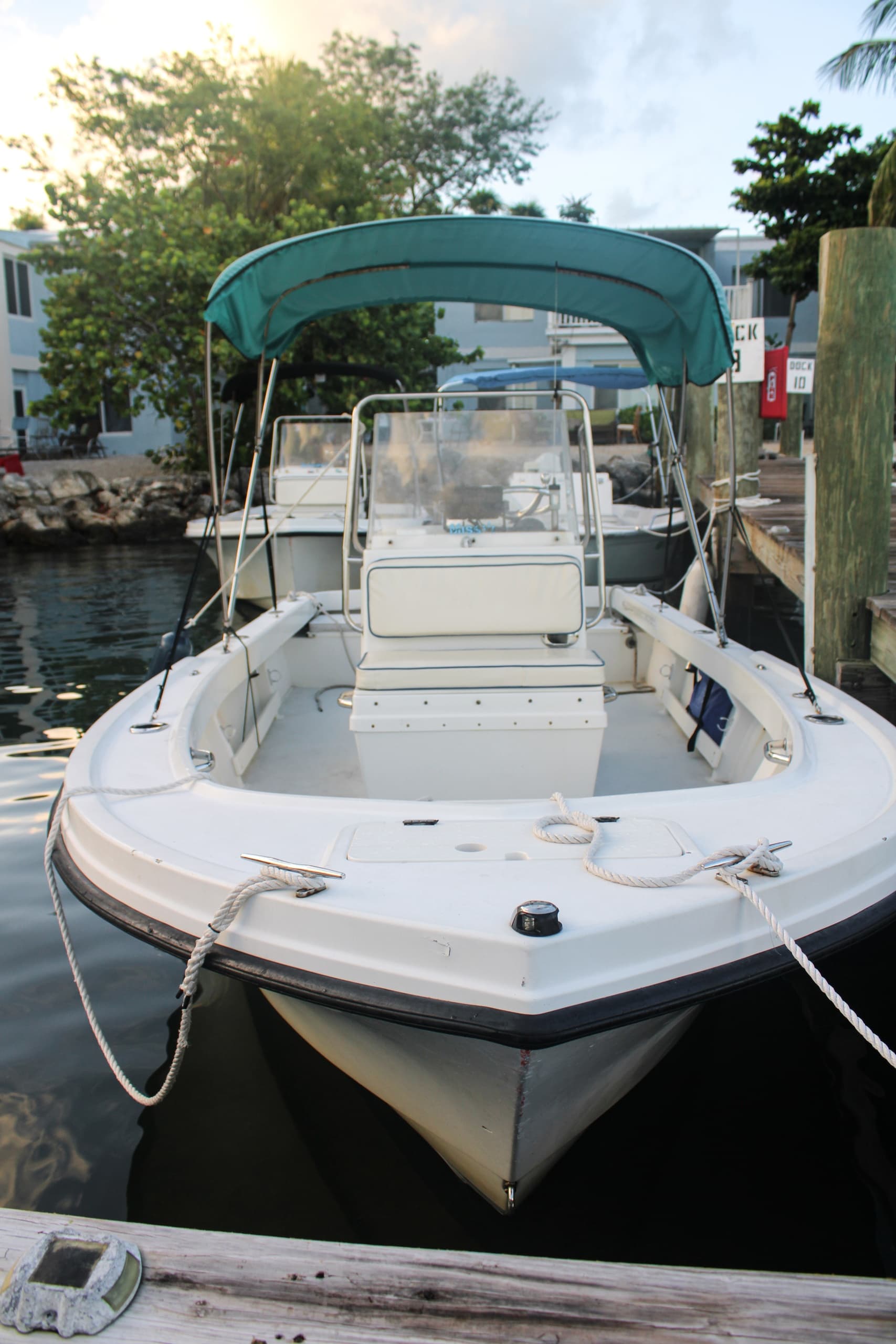 Marina boat docked with ocean backdrop, leisure boat rental