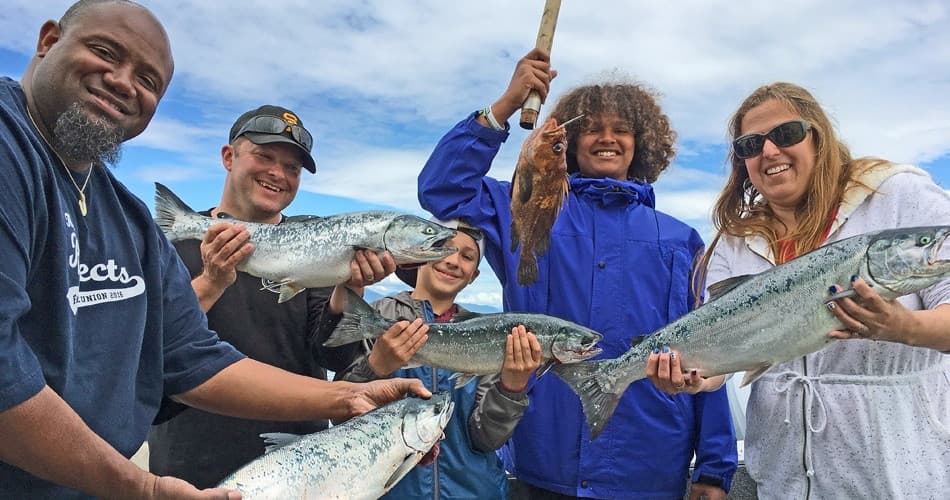 Group of anglers with caught salmon on Alaska charter