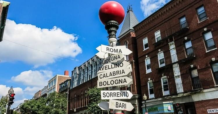 Directional signpost in Boston North End streetscape, sunny