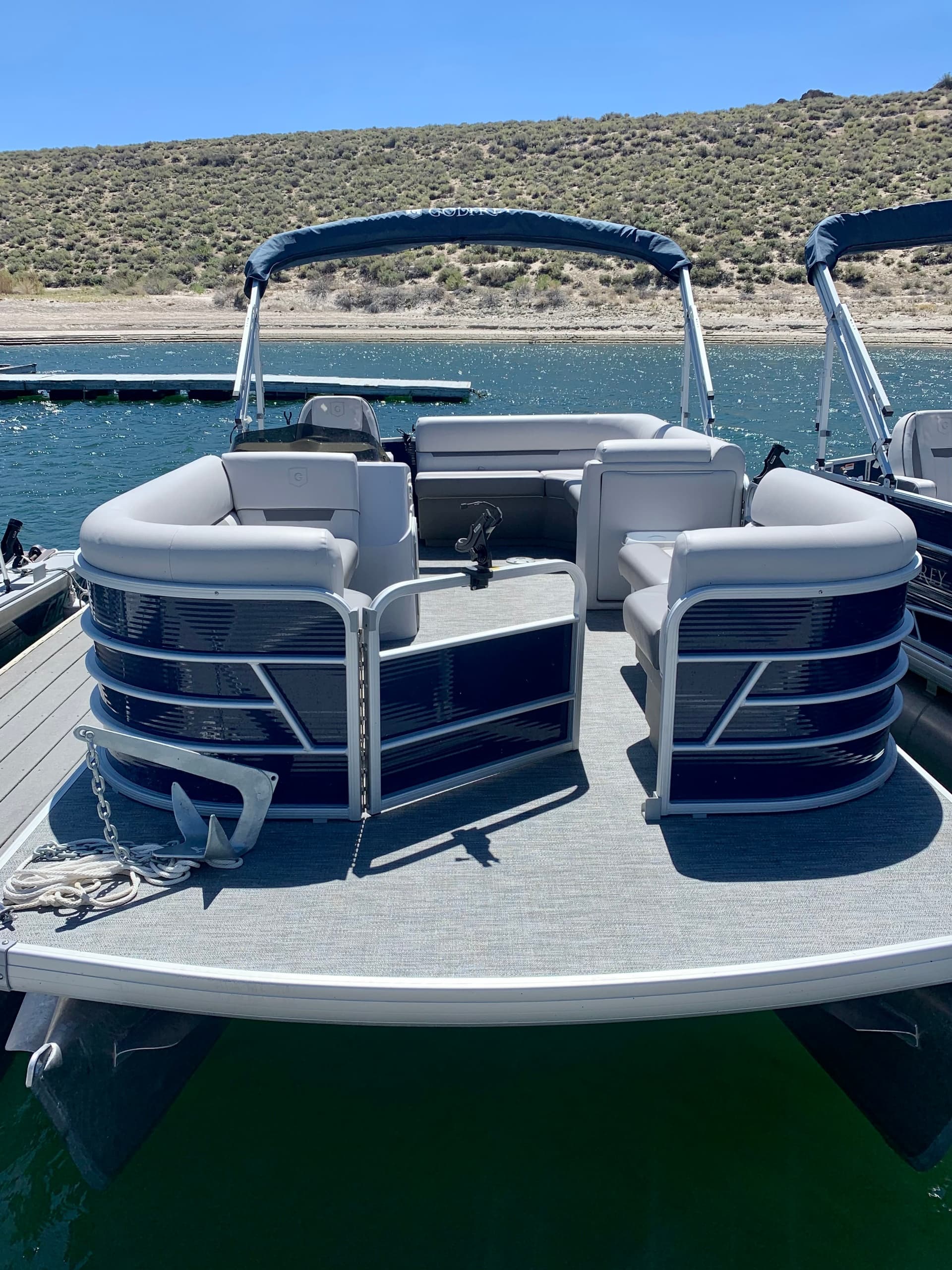 Front view pontoon boat on Crowley Lake, calm waters