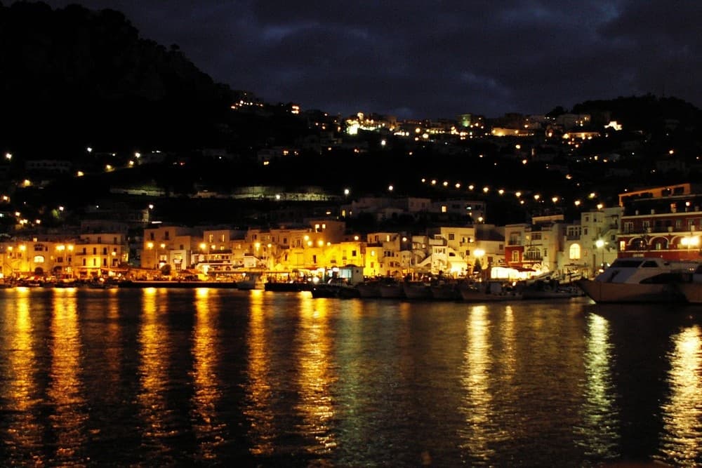 Night harbor reflections along Amalfi Coast waterfront