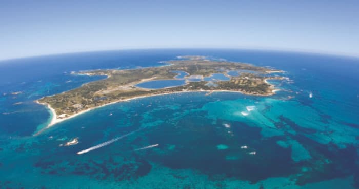 Aerial view of island and turquoise reef, scenic coastal tour