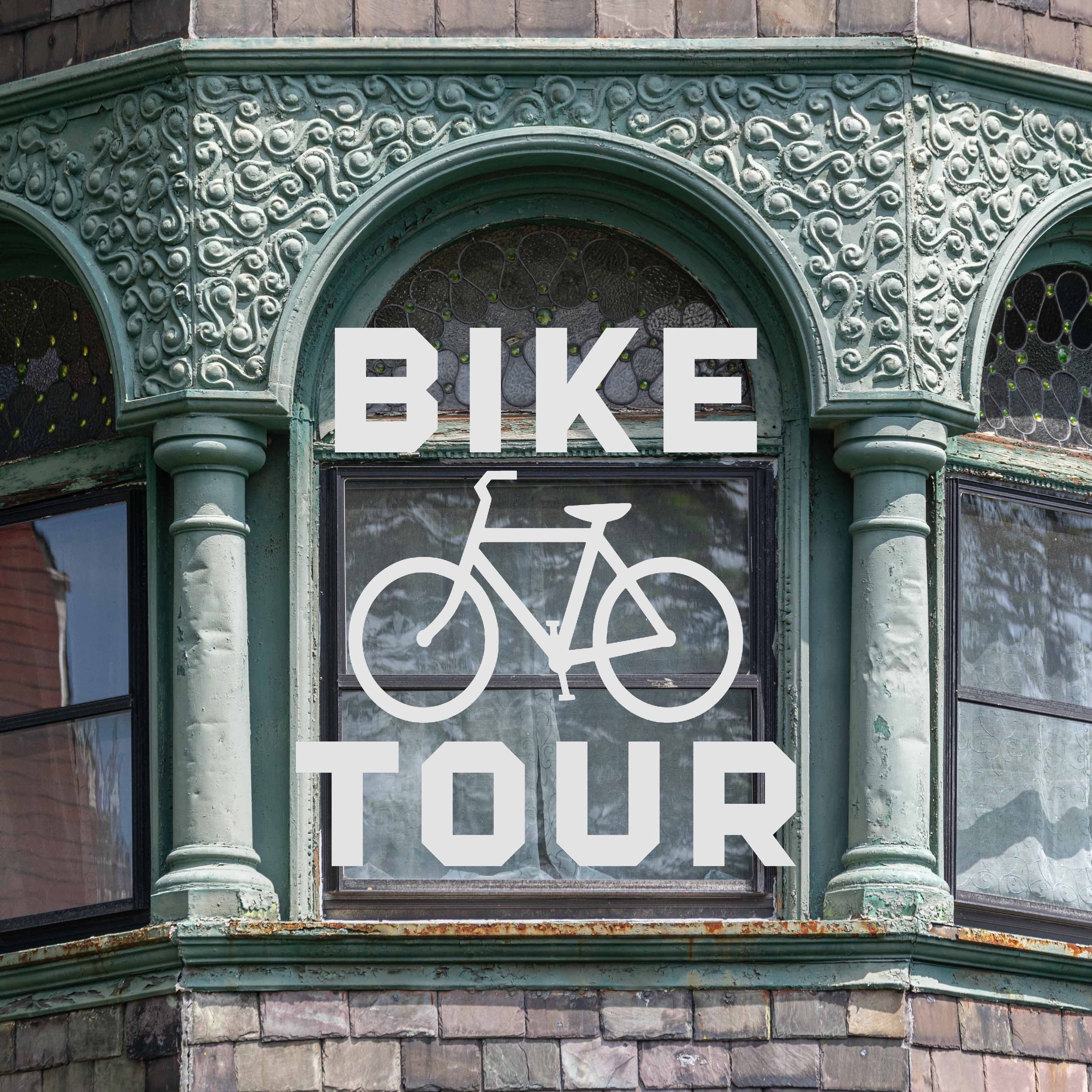 Vintage storefront 'Bike Tour' sign on ornate Chicago building
