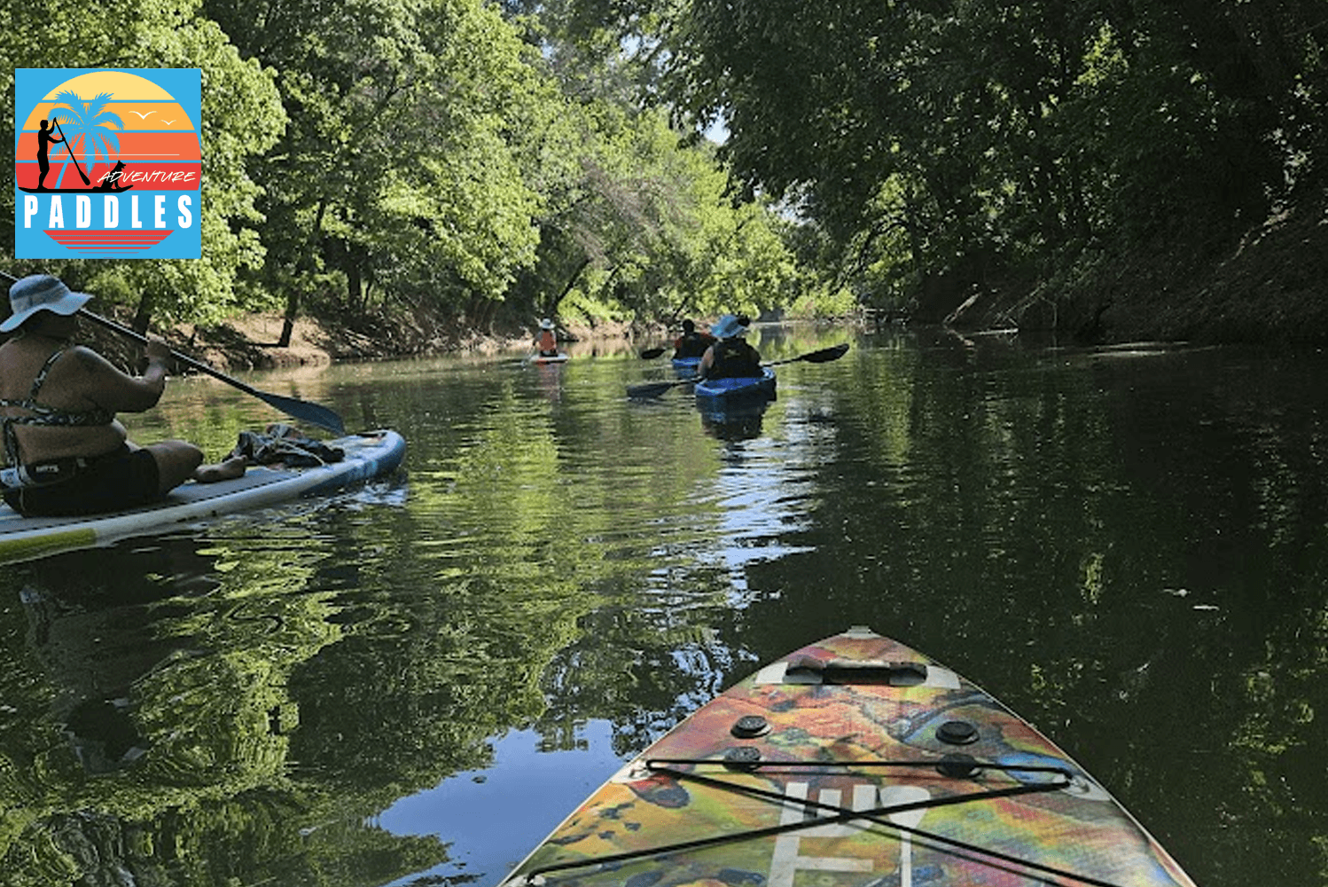 Kayak POV through tree-lined river, paddling a tranquil waterway