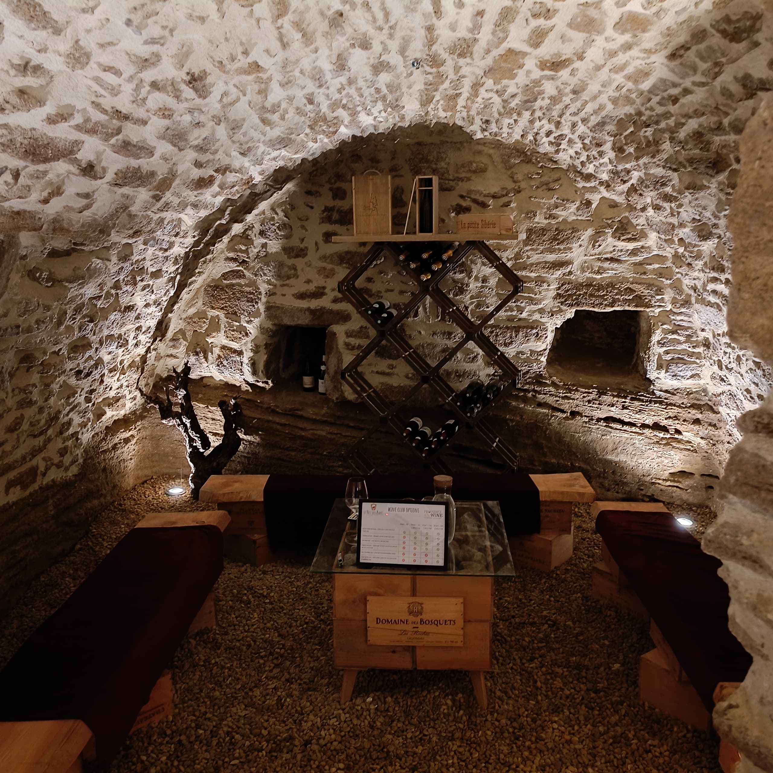 Wine tasting in dim stone cellar room in Provence, France